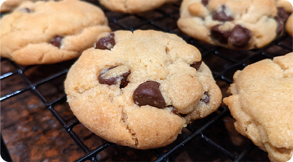 Delicious chocolate chip sugar cookies rolled in sugar cooling on a wire rack.