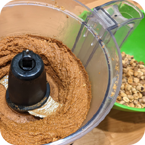 Close-up of freshly blended homemade peanut butter in a food processor